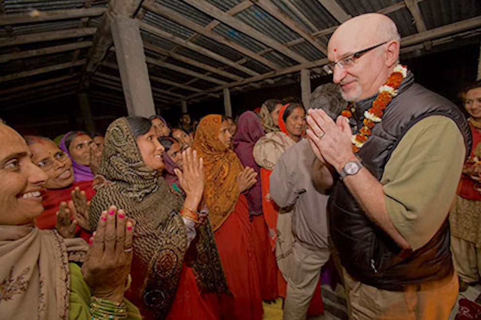 Pierre Ferrari, CEO of Heifer International, participates with community members in a celebration.