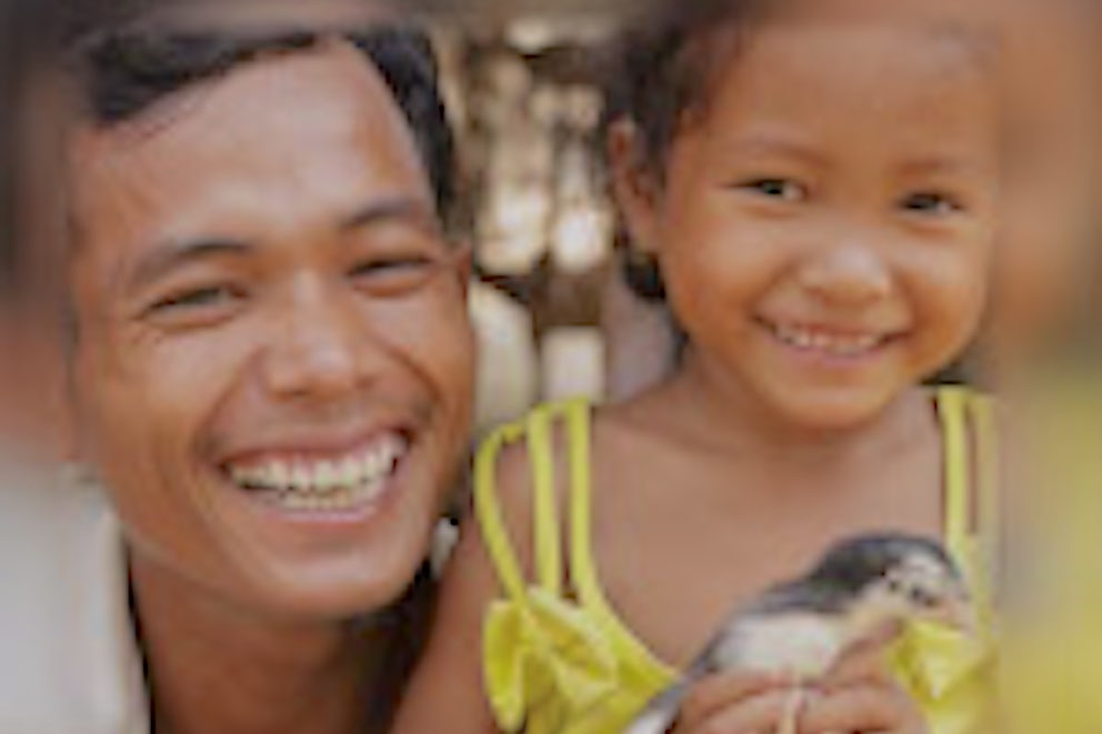 Father and Daughter holding a chick