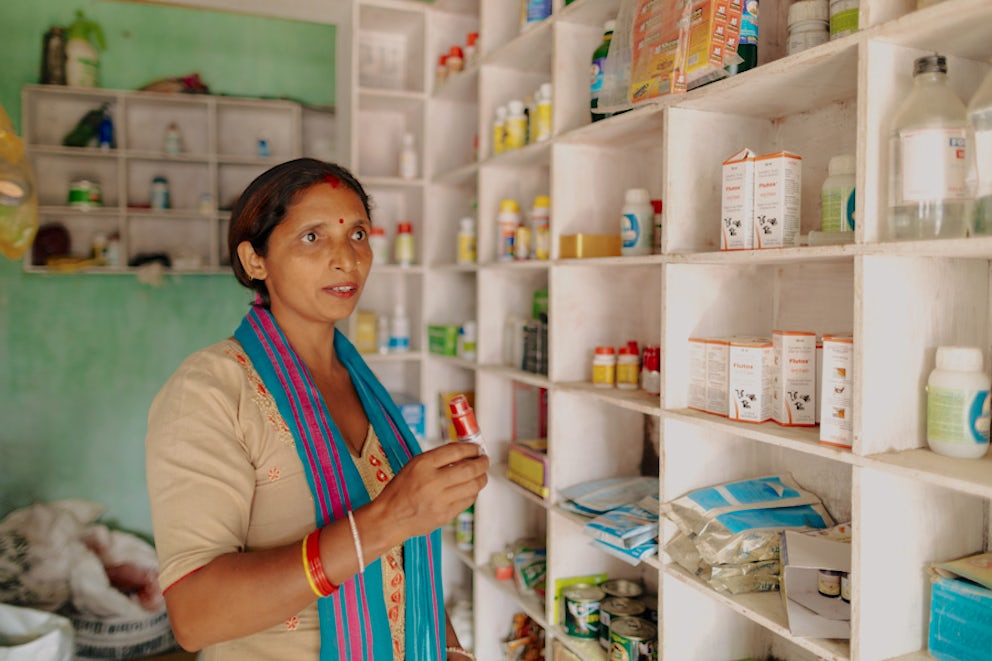 animal health worker examining medicine on a shelf