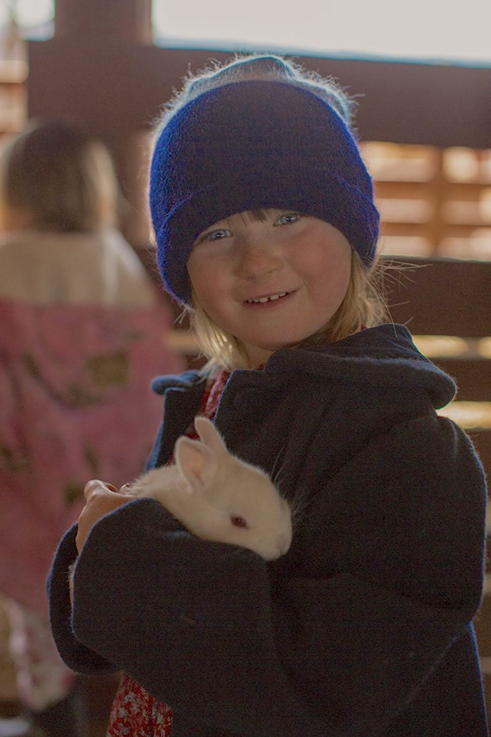 Child holds hope basket rabbit