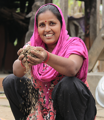 Bindu separates fodder seeds to feed her livestock. 