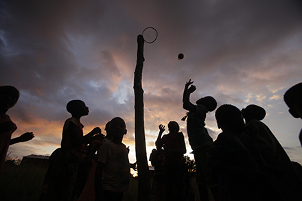 children play netball at dusk