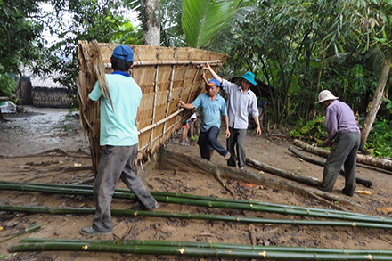 Labor unit members build a cowshed in Binh Phu.