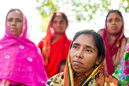 Monira sits with some of the women in her self help group.