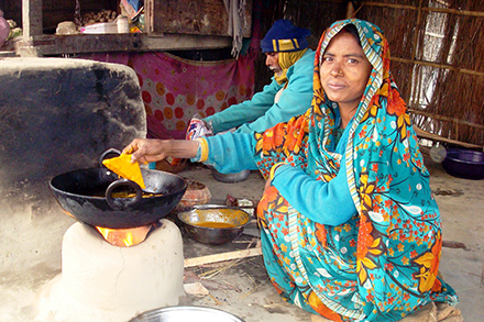 Renu makes Pakoda (snacks) in her shop while her husband assists.