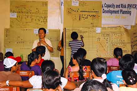 People in the village of Angas gather for a CMDDR workshop with HEED.