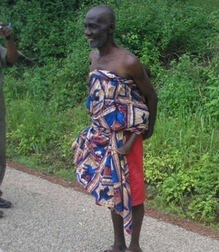 Agya Yaw carrying his granddaughter on his back