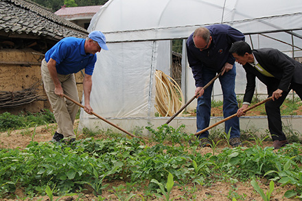 Elanco staffers help on a farm