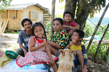 Ricardo Dillo and family outside their newly-rebuilt home.