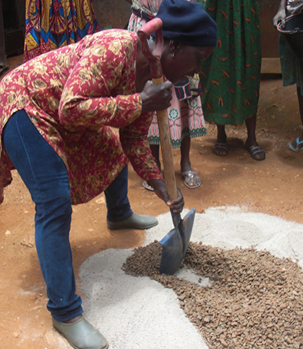 Margarette Eyebe demonstrates how to mix concrete for a biosand filter.