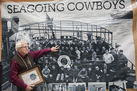 A seagoing cowboy points to himself aboard a ship that delivered animals to families in war-torn Europe in the 1940s. 