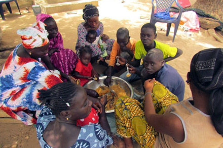 Gagnessiri's family sits down together to eat lunch.