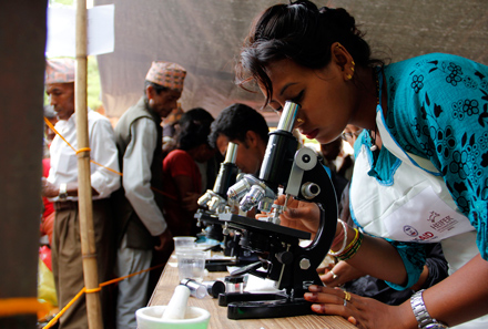 techs look through microscopes