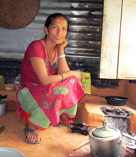 Devi inside her tin house.