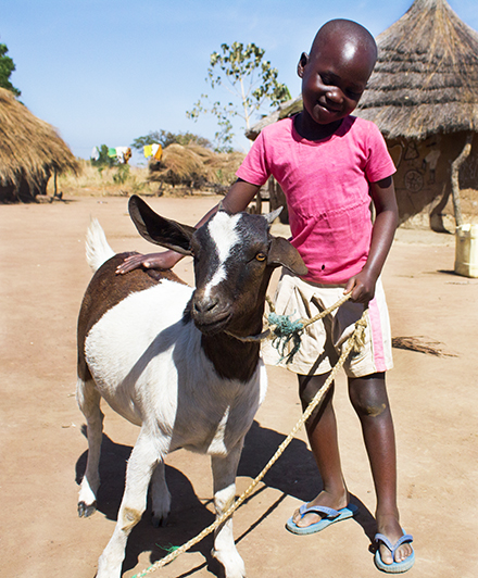 Josephine's granddaughter Cecila with Heifer the goat.