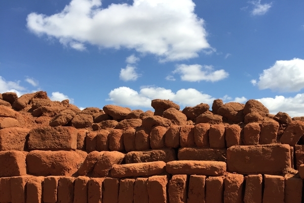 red bricks stacked under a blue sky