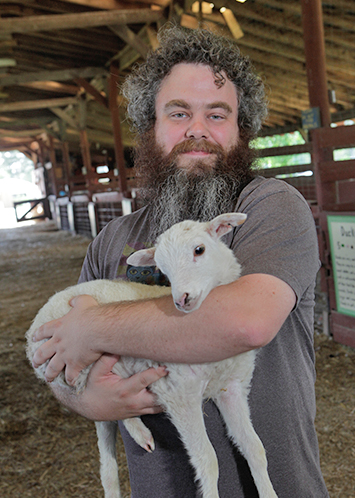Patrick Rothfuss holds a lamb