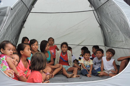 children taking refuge in a tent