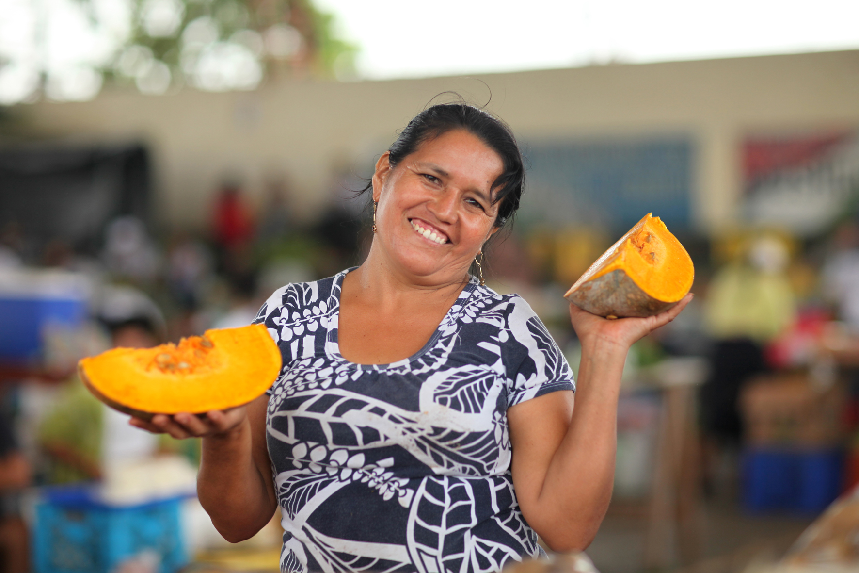 A Heifer participant holds up fruit