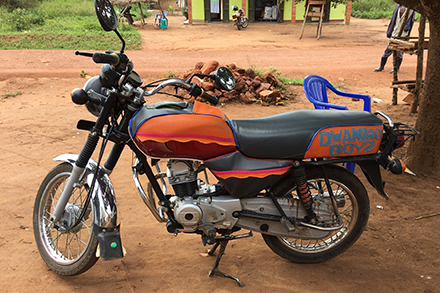 The young men who deliver milk like to add flair to their motorcycles. 