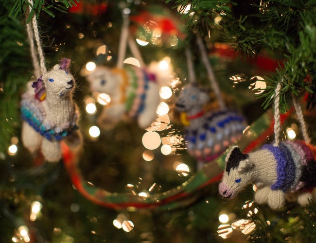 Knitted ornaments hanging in a Christmas tree.
