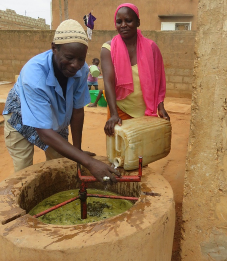 Mamadou and Yacine feed their biogas digester.
