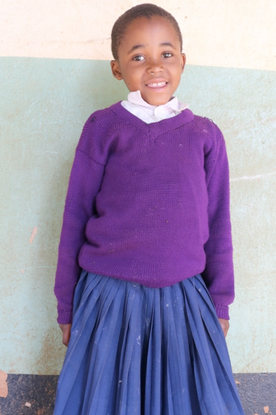 Eight-year-old Mercy Mlawa smiles for a photo. 