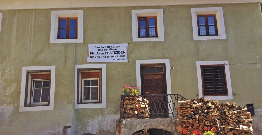 Banner protesting pesticides hung under a window.