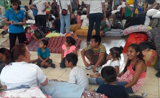 Families gathered in a makeshift shelter.