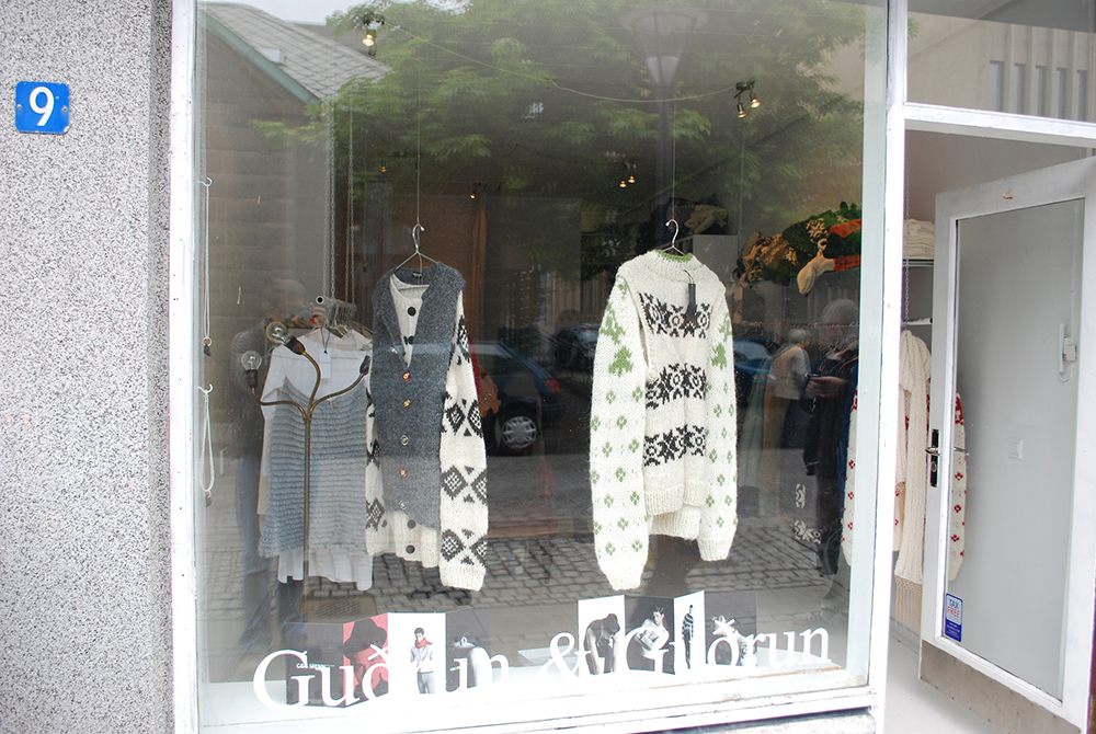 Sweaters in a storefront window.