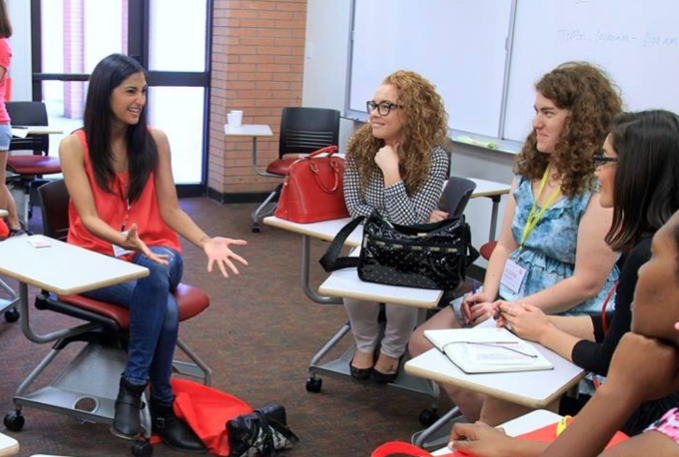 Asha Daya mentoring a group of high school girls.