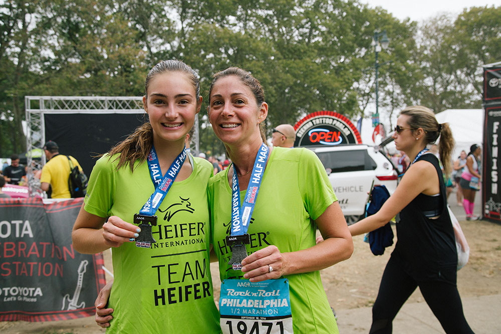 Jane and Carrol Overend show off their half-marathon medals.