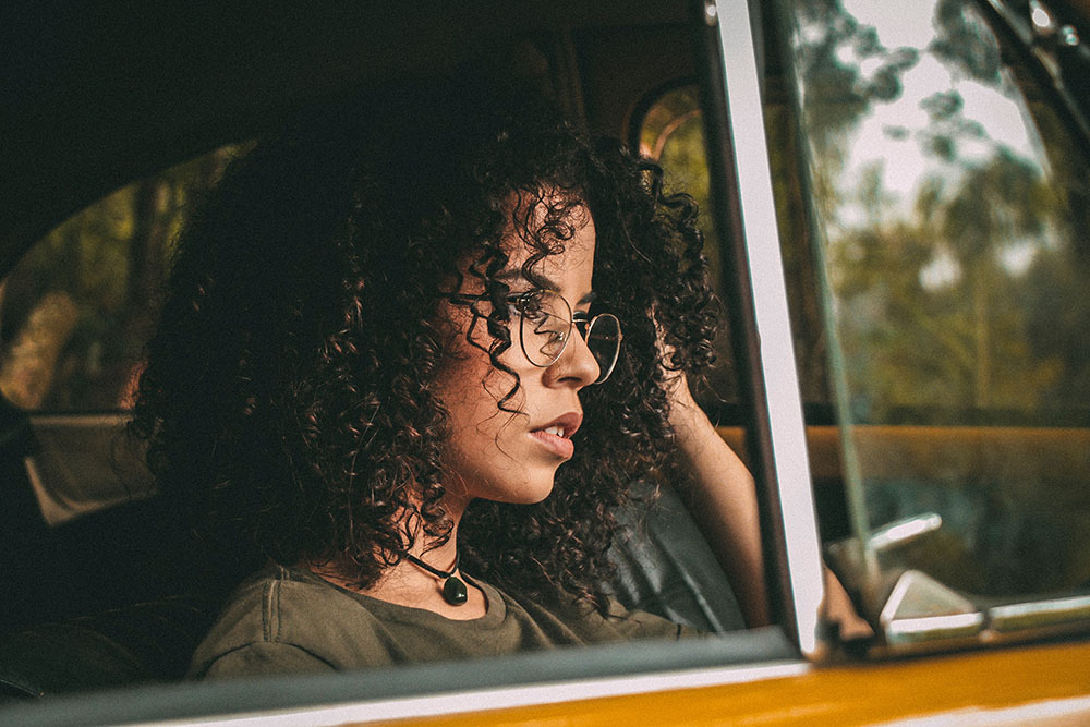 A young woman in a car.