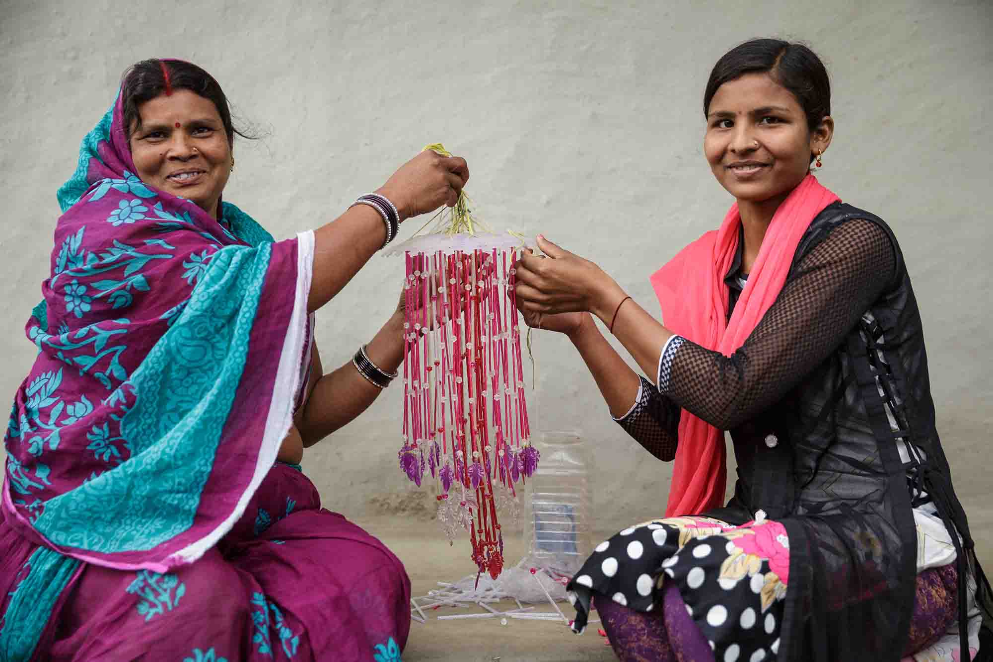 Munni Devi and her daughter Preeti Kumar, 19, make a wind chime together.