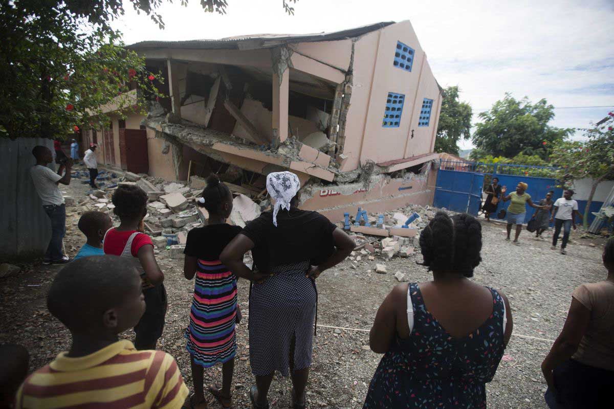 Haitians look at damage caused from a 5.9 magnitude earthquake. AP Photo Dieu Nalio Chery 