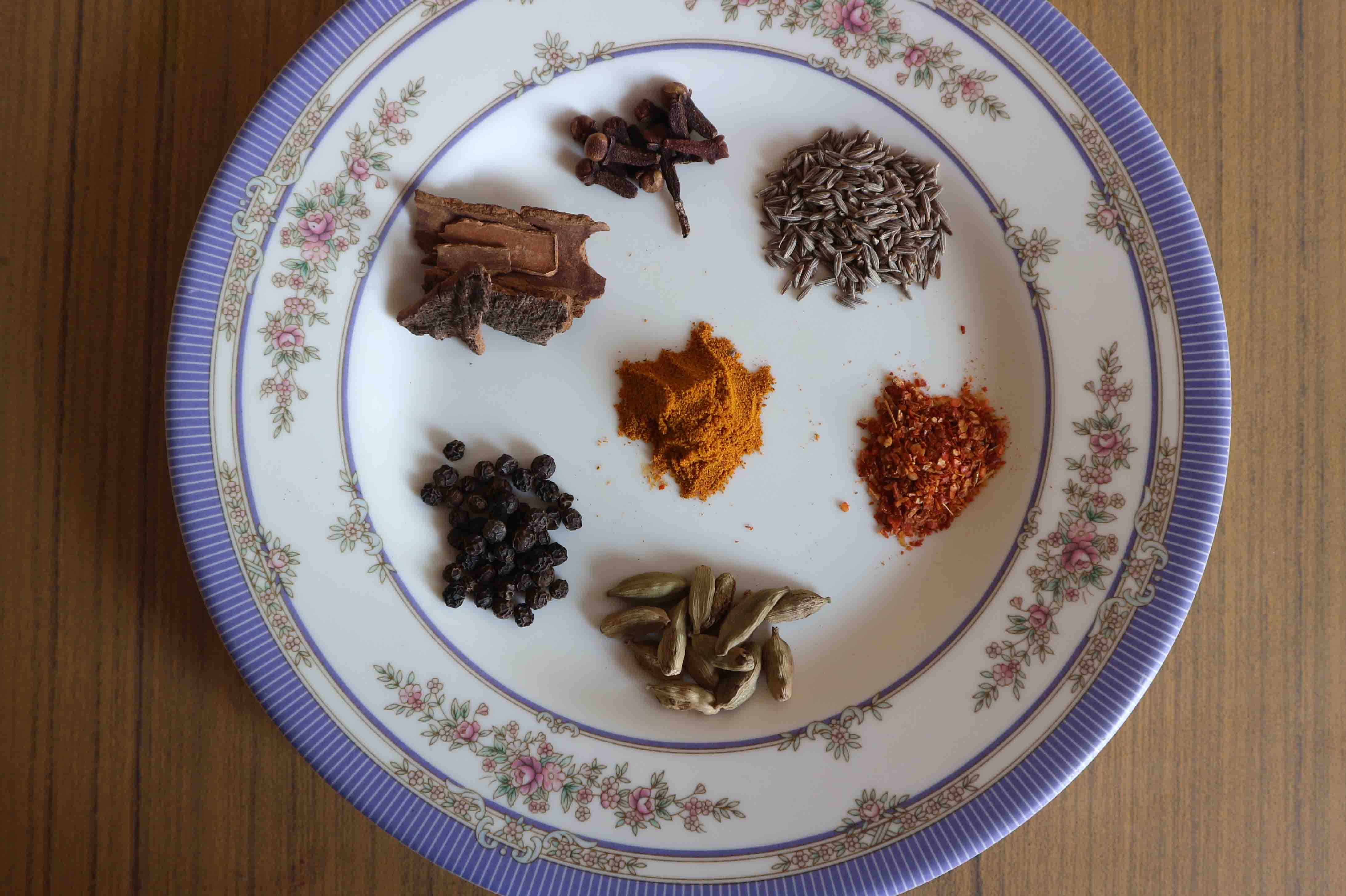 Spices for the curry include cumin, tumeric, cinnamon, cardamom, black pepper, cloves and red chili flakes.