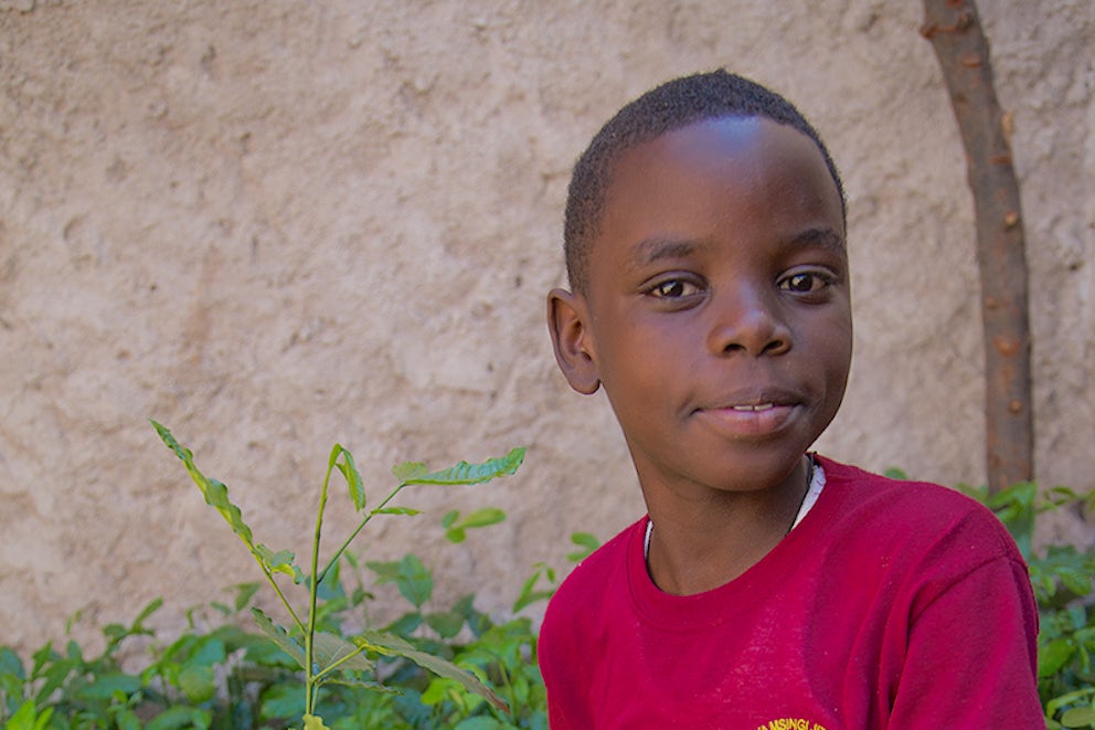 Frederick shows off a seedling that is almost ready to plant.