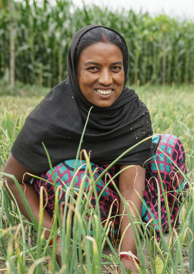 Lakshmi Kisku and her daughter Rashmi work in their onion patch together.