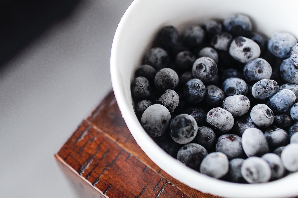 A bowl of frozen blueberries.