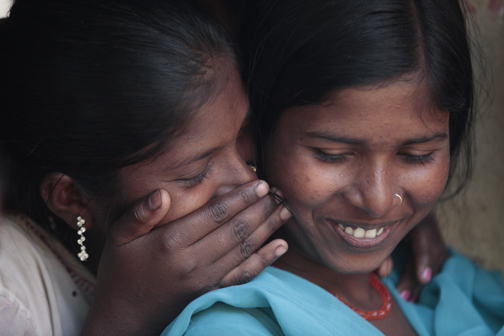 Pooja Kumri, 12, and her sister Priyanka, 18, share a secret in India's Shitlapur village.