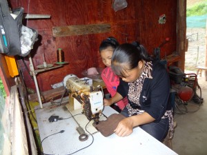 Studying Mom's technique for making leather shoes