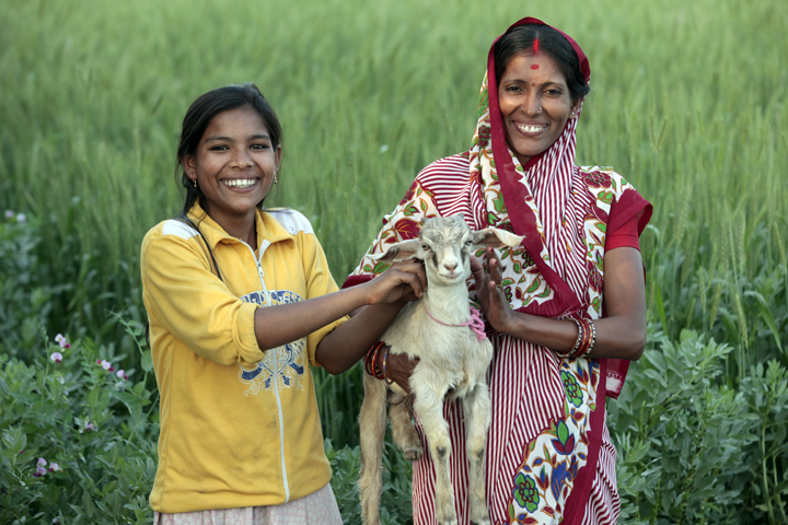 Rameba Devi and her daughter Madhu,  with a family goat  in the Shitlapur village of India.