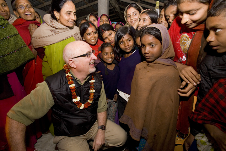Heifer International's CEO Pierre Ferrari listens to a group meeting of the Pooja women's group.