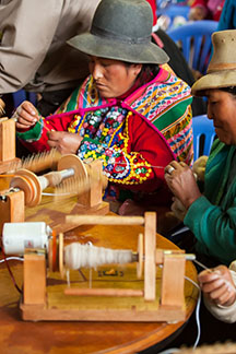 Cusco woman learns to spin alpaca fiber into thread. 