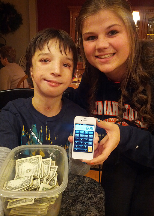 Ryan and his cousin count money from a fundraiser.