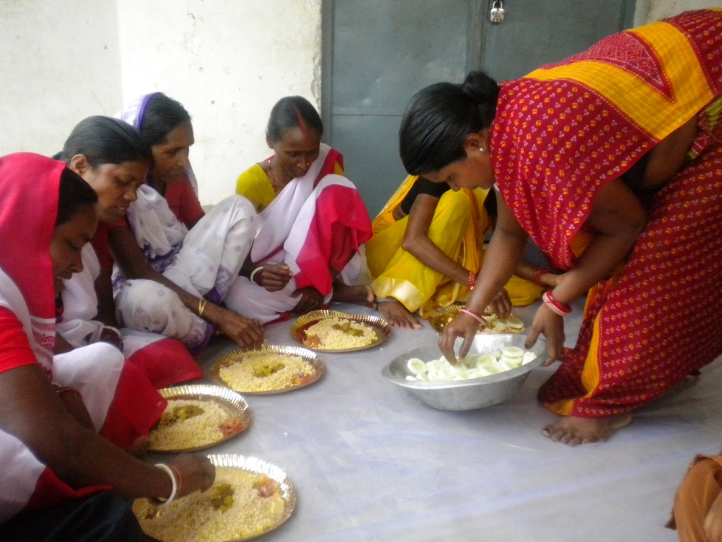Leela Devi manages food stuffs as a project management committee member during a training program of self help group members.