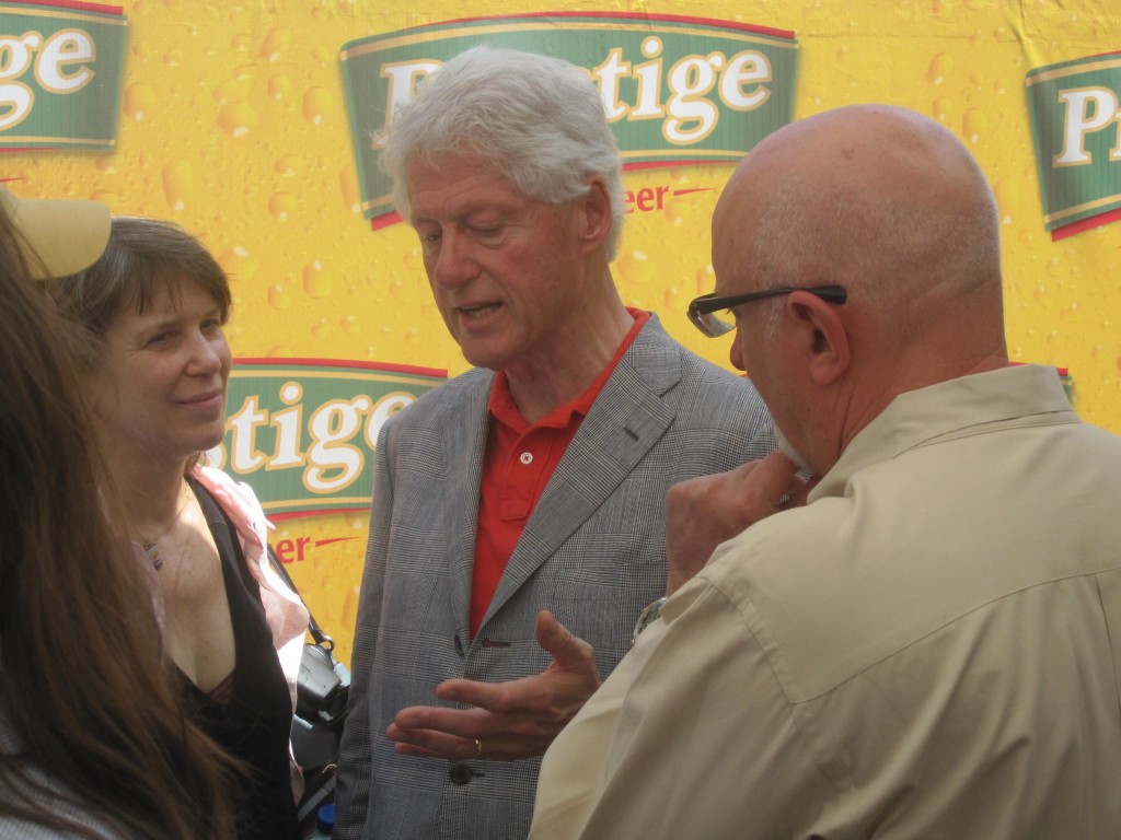 President Clinton speaks with Heifer's Pierre Ferrari and other delegates at the Heineken brewery in Port au Prince that produces the Haitian beer Prestige. 