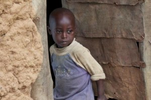Emmanuel stands outside his family's house in the Mareba district of Rwanda.