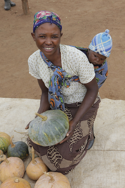 Harriet Shiyanda and her son Joshua Chali show off their pumpkins in the Willie Mulenga village, Zambia. Photo by Russell Powell, courtesy of Heifer International.