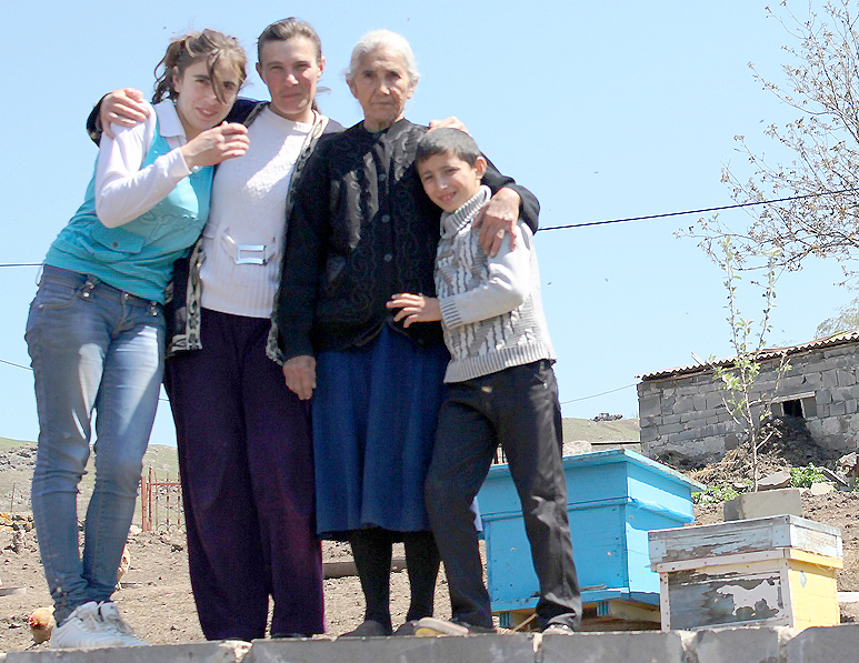 Astghik, Kristine, granny Gohar and Vahe of the Nazlukhanyan family stand next to their bee farm. Photo by Liana Hayrapetyan, Communication and PR Coordinator, Heifer Armenia